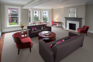 Image of a living room, including two couches, two armchairs, and a fireplace