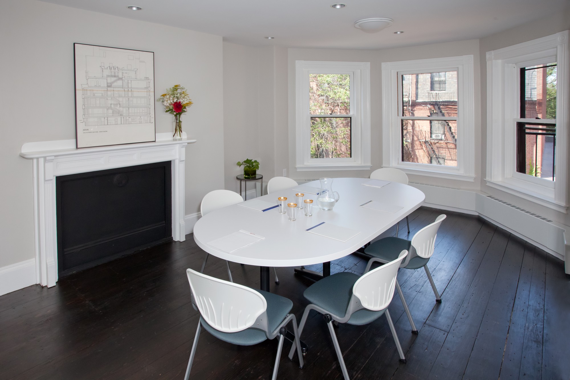 Image of a meeting room featuring six chairs around a small conference table