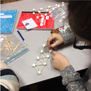 STEM program participants experiment with different structural models using marshmallows and toothpicks.