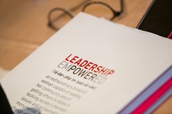 Image of a handbook with the words "Leadership Empowered"